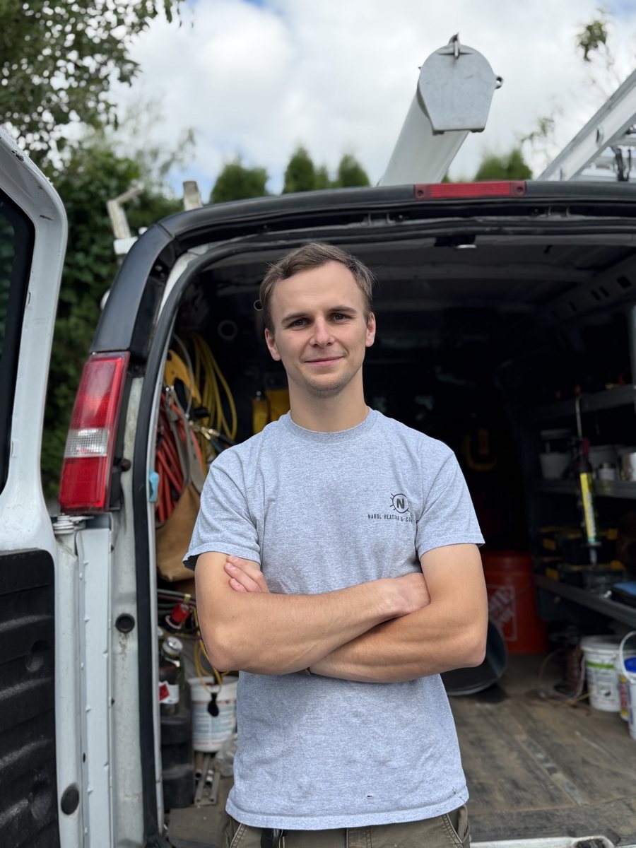 Andrew Naroyskiy, owner of NAROL Heating & Cooling, in front of his work van